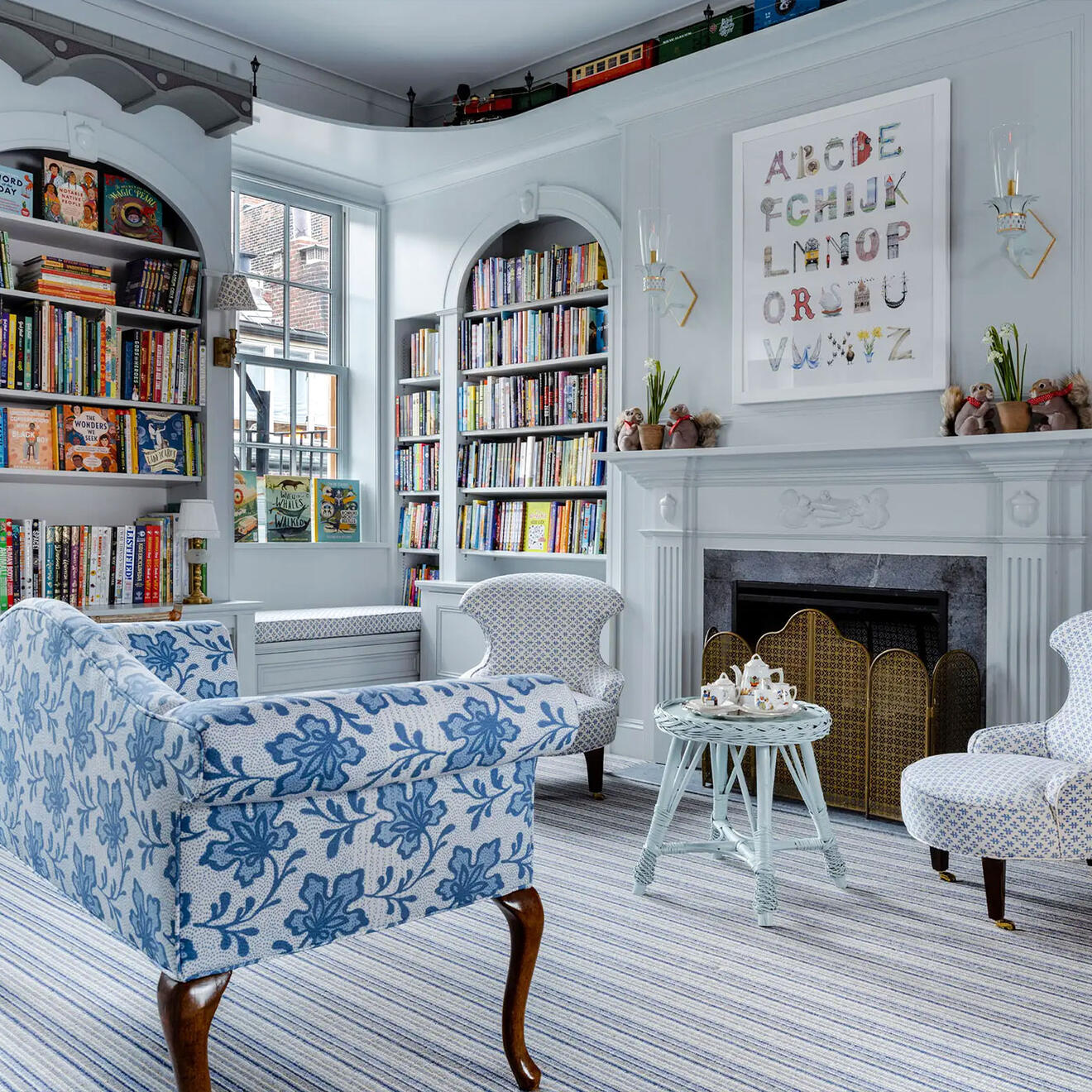 Children's room at Beacon Hill Books & Cafe in Boston with built-in bookshelves, fireplace, and custom architectural detailing